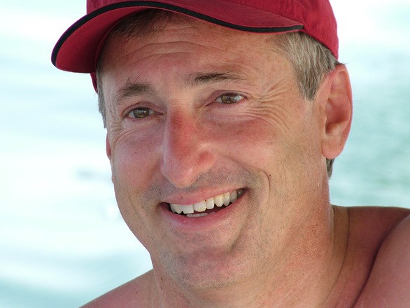 Man wearing a red hat smiling 